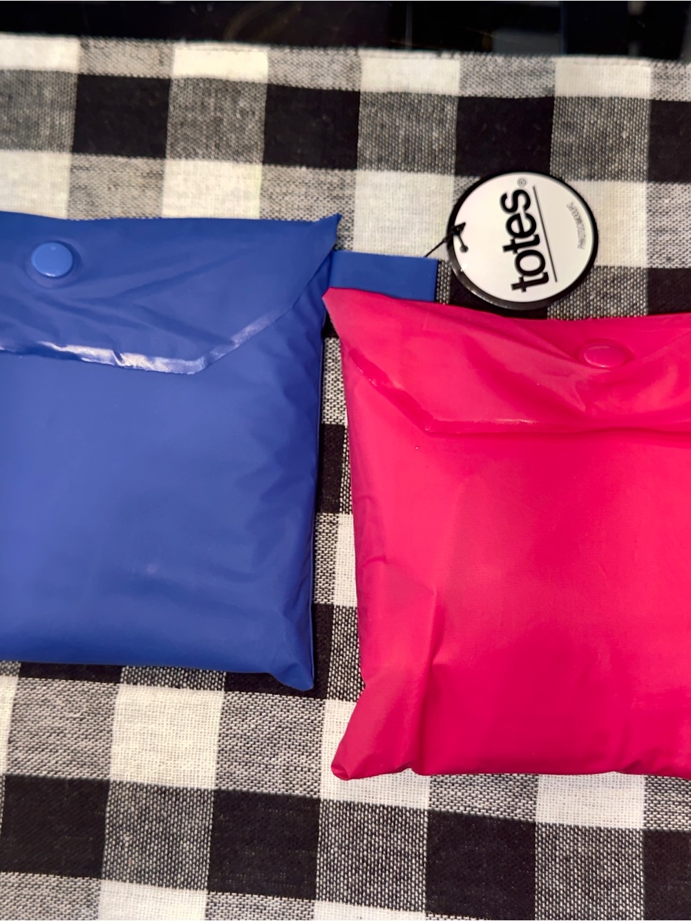 totes Packable Reusable ponchos in Blue and Pink